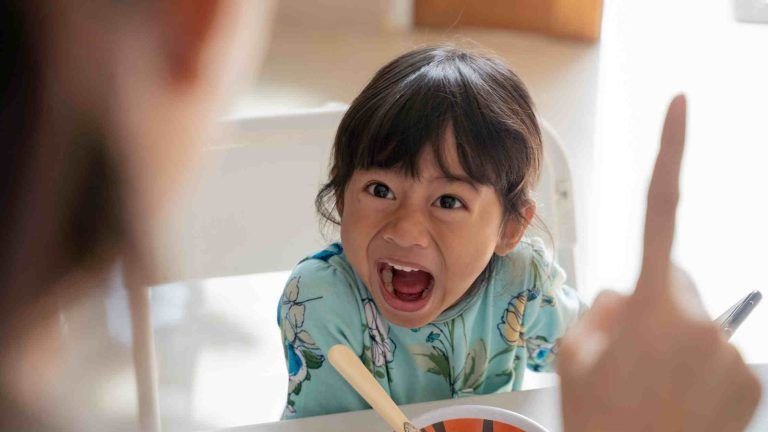 Child absorbed in smartphone screen — representing smartphone addiction in kids